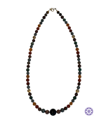 A beaded necklace featuring alternating dark green, brown, and black round beads, with a large textured black bead at the center front and a silver-tone clasp at the top, shown on a plain white background.