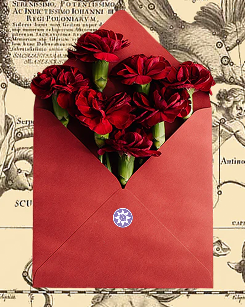 Red envelope with a heart-shaped arrangement of red flowers on an old document background