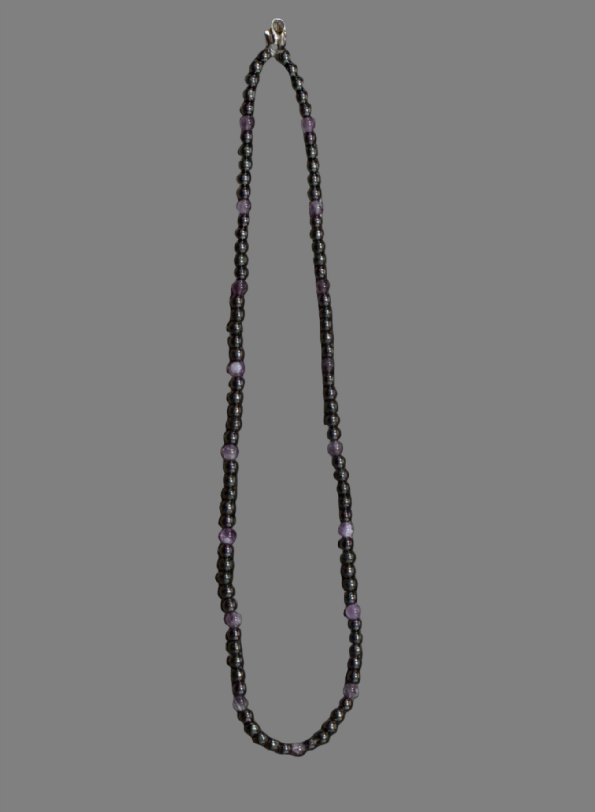 A Capricorn Necklace designed with Amethyst, Magnetite and Hematite gemstones. The size of the necklace:  16 inches (4 mm). A beautiful one-of-a-kind necklace created by AstroCreations, makers of Zodiac jewelry.